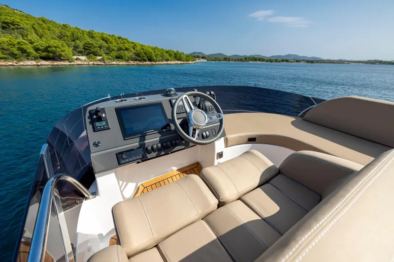  Yacht Photos Pics 2026 Nimbus 405 Flybridge helm with luxurious seating and scenic ocean view.