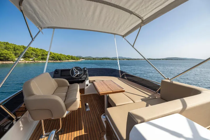  Yacht Photos Pics Luxurious 2026 Nimbus 405 Flybridge yacht with spacious seating and scenic ocean view.