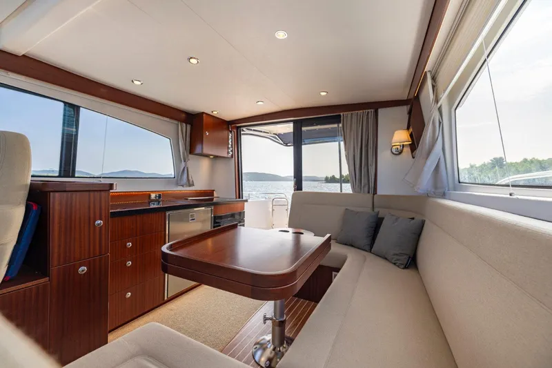  Yacht Photos Pics Luxurious interior of 2026 Nimbus 405 Flybridge yacht with elegant seating and wooden finishes.