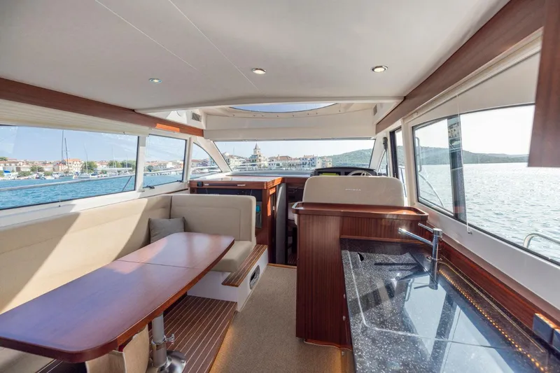  Yacht Photos Pics Luxurious interior of 2026 Nimbus 405 Flybridge yacht with scenic water views.