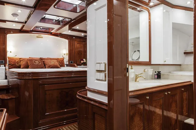 Selene Rouge Yacht Photos Pics Luxurious yacht interior with wood finishes, elegant bedding, and modern bathroom fixtures, 2021 Custom Line.