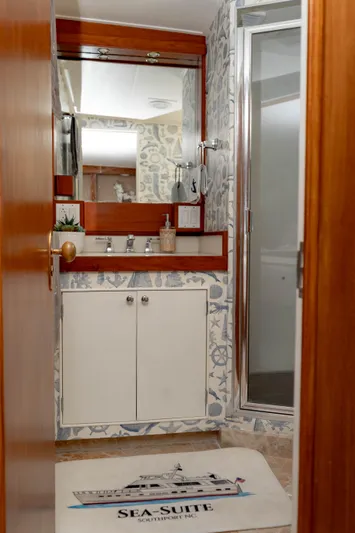 Sea Suite Yacht Photos Pics Bathroom with nautical decor, wooden accents, and a shower on a 1974 Burger model 67 yacht.