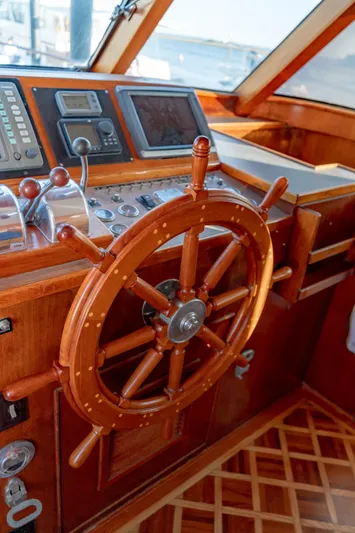 Sea Suite Yacht Photos Pics Wooden helm of a 1974 Burger 67 yacht with navigation instruments.