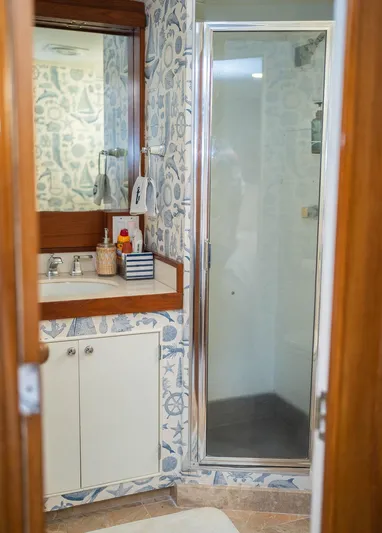 Sea Suite Yacht Photos Pics Nautical-themed bathroom with shower, mirror, and sink in a 1974 Burger model 67.
