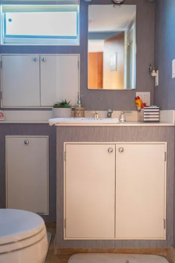 Sea Suite Yacht Photos Pics 1974 Burger 67 yacht bathroom with modern fixtures and storage cabinets.