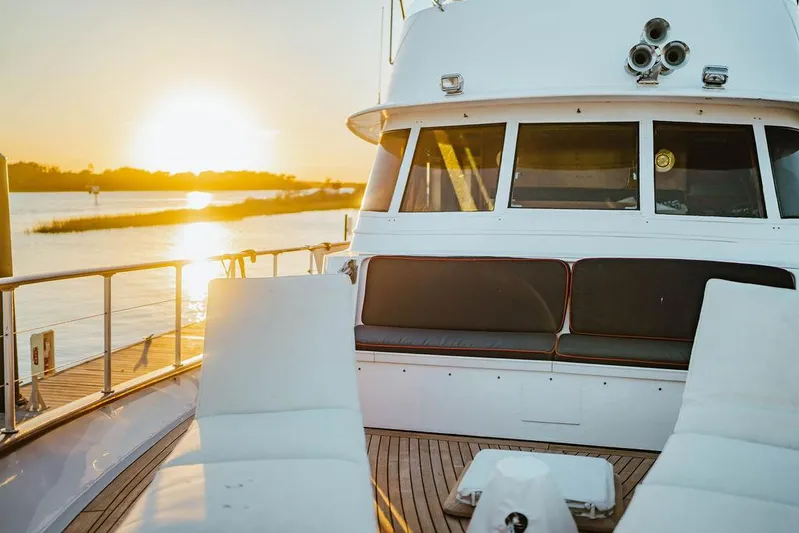 Sea Suite Yacht Photos Pics Vintage 1974 Burger 67 yacht deck at sunset, featuring elegant seating and serene water views.