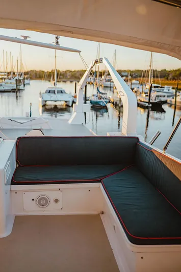 Sea Suite Yacht Photos Pics Luxurious 1974 Burger 67 yacht interior with marina view at sunset.