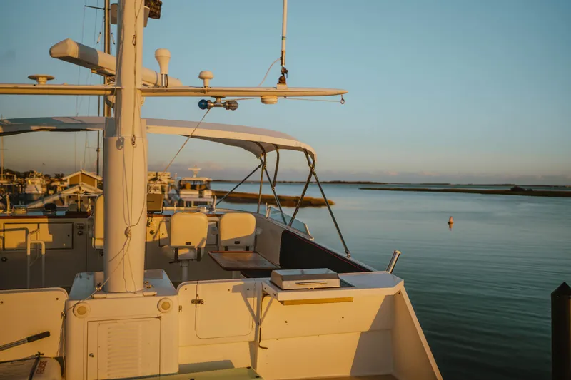 Sea Suite Yacht Photos Pics Vintage 1974 Burger 67 yacht docked at sunset, serene waterfront view.