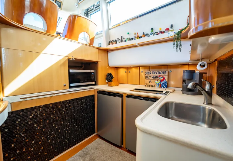  Yacht Photos Pics 1997 Viking Princess 60 Flybridge yacht kitchen with modern appliances and stylish wood cabinetry.