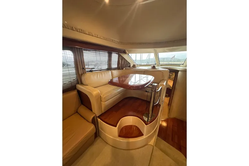 Just One More Yacht Photos Pics Luxurious interior of 2005 Sea Ray 420 Sedan Bridge yacht with elegant seating and table.