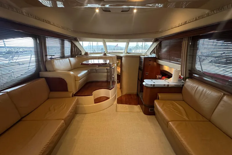 Just One More Yacht Photos Pics Luxurious interior of 2005 Sea Ray 420 Sedan Bridge yacht with leather seating and dining area.