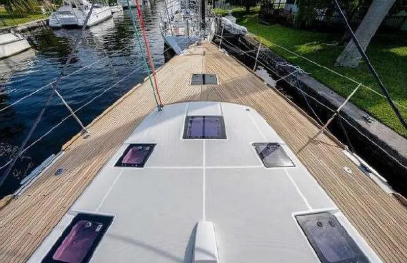 Icon Yacht Photos Pics 2014 Beneteau Sense 55 yacht deck with hatches, docked by the water.