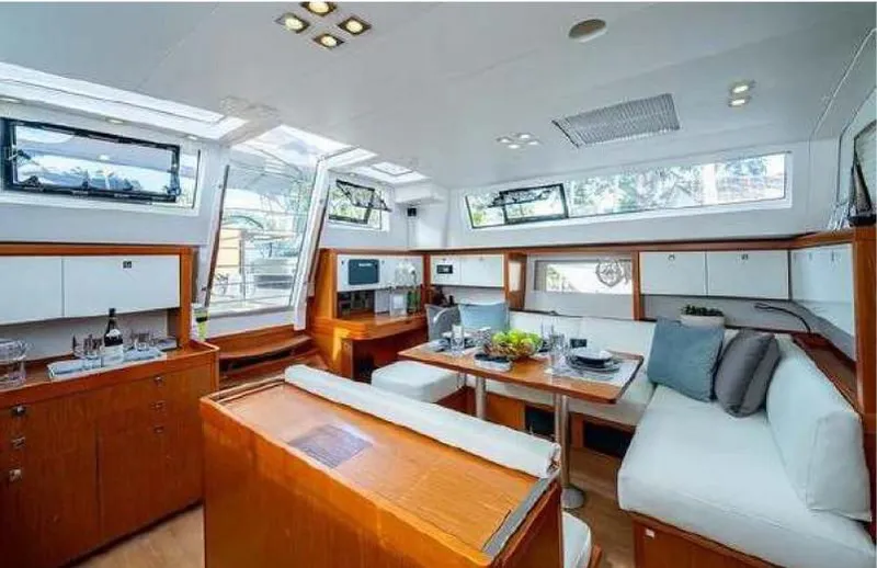 Icon Yacht Photos Pics Interior of 2014 Beneteau Sense 55 yacht, featuring modern dining area and kitchen.
