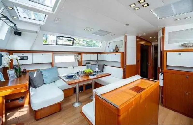 Icon Yacht Photos Pics Interior of 2014 Beneteau Sense 55 yacht with modern seating and dining area.