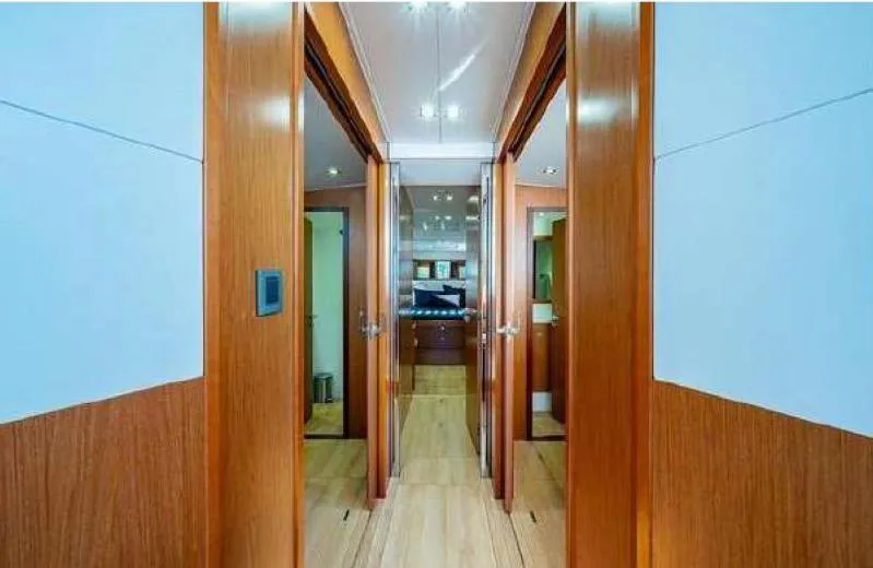 Icon Yacht Photos Pics Interior hallway of 2014 Beneteau Sense 55 yacht with wooden finishes.