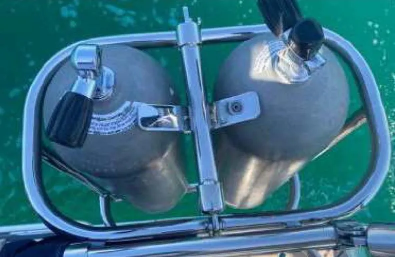 Icon Yacht Photos Pics Two scuba tanks secured on a Beneteau Sense 55 yacht, 2014 model, over turquoise water.