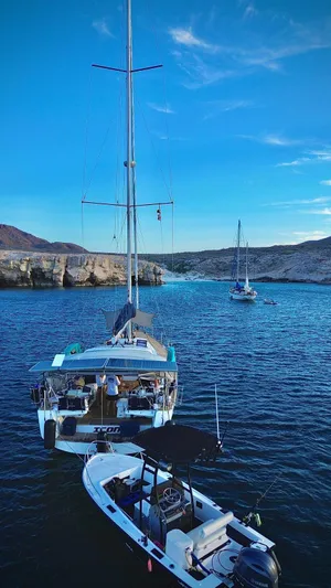 Icon Yacht Photos Pics 2014 Beneteau Sense 55 yacht anchored in scenic coastal waters.