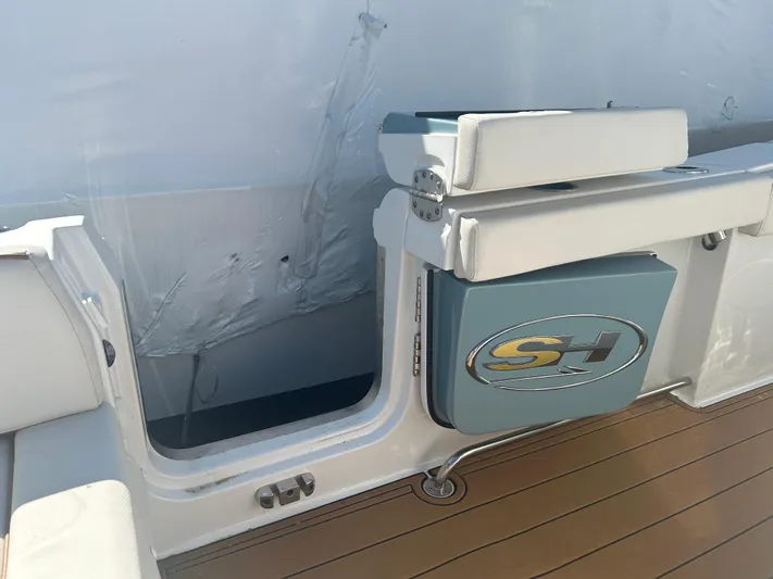  Yacht Photos Pics 2022 Sea Hunt Ultra 275 SE boat interior with seating and storage compartment.