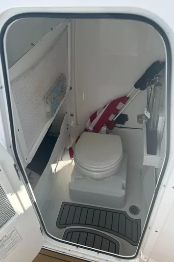  Yacht Photos Pics 2022 Sea Hunt Ultra 275 SE boat interior with compact marine toilet.