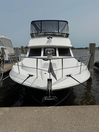 Y Knot Yacht Photos Pics 1997 Carver 405 Aft Cabin yacht docked at marina, front view.
