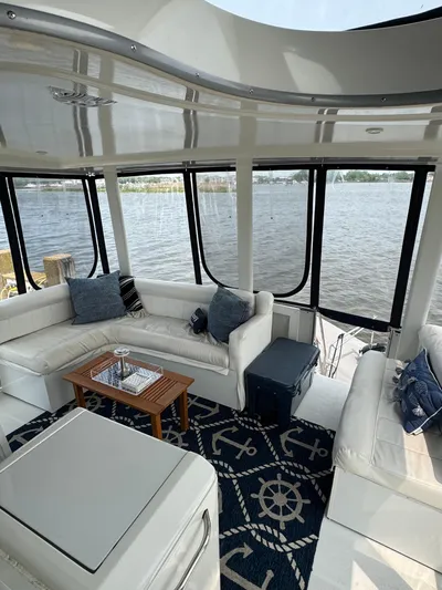 Y Knot Yacht Photos Pics 1997 Carver 405 Aft Cabin interior with white seating and nautical-themed decor.