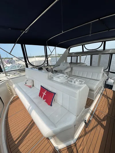 Y Knot Yacht Photos Pics 1997 Carver 405 Aft Cabin yacht interior with white seating and nautical decor.