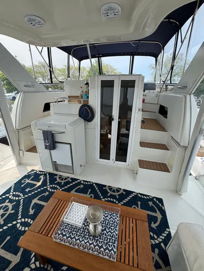 Y Knot Yacht Photos Pics 1997 Carver 405 Aft Cabin interior with nautical decor and wooden accents.