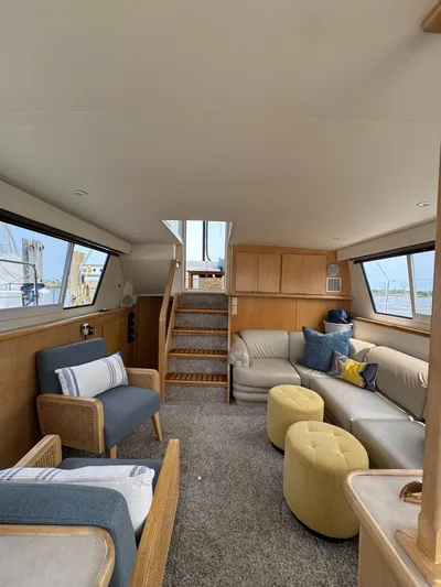 Y Knot Yacht Photos Pics 1997 Carver 405 Aft Cabin interior with cozy seating and nautical decor.