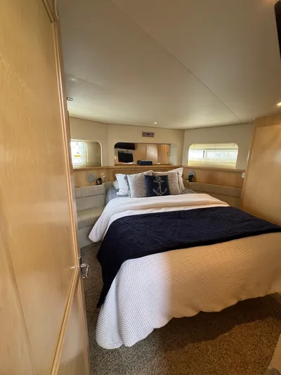 Y Knot Yacht Photos Pics 1997 Carver 405 Aft Cabin bedroom with cozy bed and nautical decor.