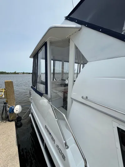 Y Knot Yacht Photos Pics 1997 Carver 405 Aft Cabin yacht docked by the water.