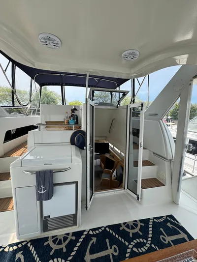 Y Knot Yacht Photos Pics 1997 Carver 405 Aft Cabin interior with nautical decor and open cabin doors.