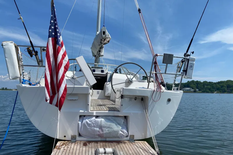  Yacht Photos Pics 2015 X-Yachts Xc-35 sailboat docked, featuring American flag and scenic water view.