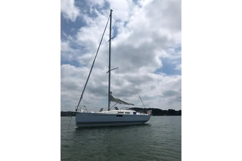 Yacht Photos Pics 2015 X-Yachts Xc-35 sailboat on calm water under cloudy sky.