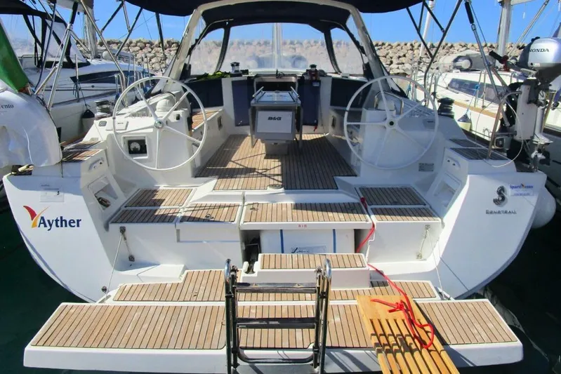  Yacht Photos Pics 2019 Beneteau Oceanis 41.1 yacht with dual steering wheels and teak deck in marina.