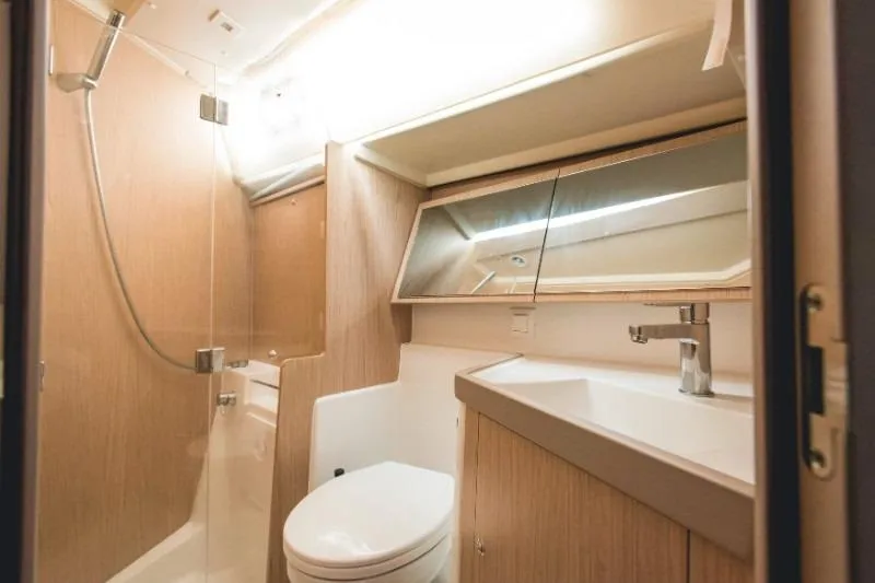  Yacht Photos Pics Modern bathroom in 2019 Beneteau Oceanis 41.1 yacht with shower, sink, and toilet.