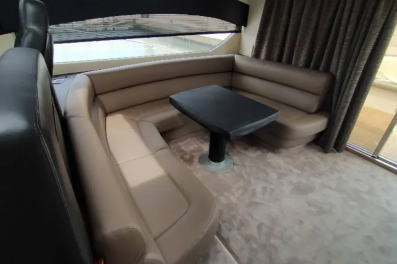  Yacht Photos Pics Luxurious interior of 2007 Sunseeker Predator 62 yacht with leather seating and table.