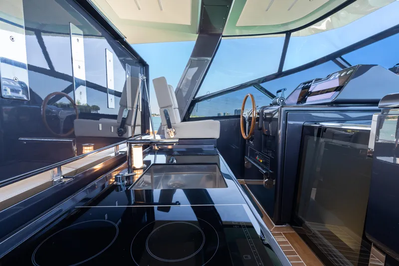 Yanina Yacht Photos Pics Luxurious interior of 2019 CNM Continental 54T yacht with modern kitchen and steering area.