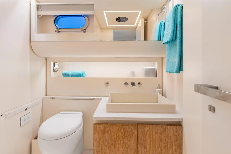 Yanina Yacht Photos Pics Luxurious yacht bathroom with modern fixtures, blue towels, and sleek design on CNM Continental 54T.