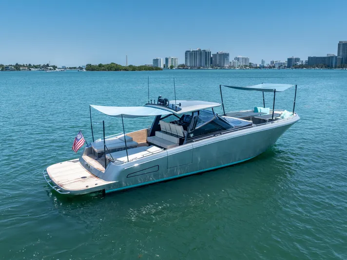 Yanina Yacht Photos Pics 2019 CNM Continental 54T yacht on calm water with city skyline background.