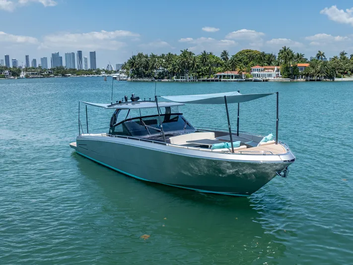 Yanina Yacht Photos Pics 2019 CNM Continental 54T yacht on serene water with city skyline and palm trees.
