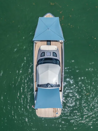 Yanina Yacht Photos Pics Aerial view of 2019 CNM Continental 54T yacht with blue canopies on green water.