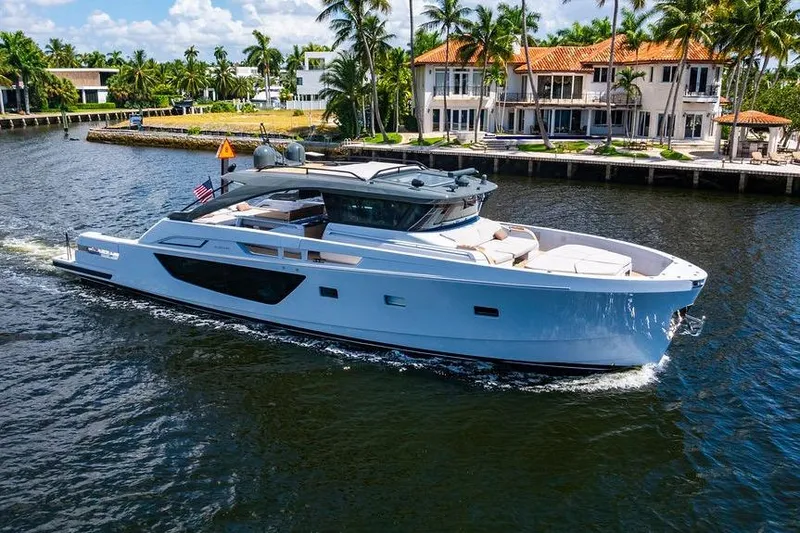 Snack Money Yacht Photos Pics 2023 Bluegame BG 72 yacht cruising near luxury waterfront homes.