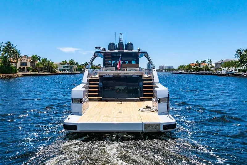 Snack Money Yacht Photos Pics 2023 Bluegame BG 72 yacht cruising on a sunny day, rear view.