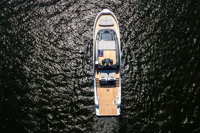 Snack Money Yacht Photos Pics Aerial view of 2023 Bluegame BG 72 yacht on shimmering water.