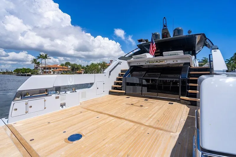 Snack Money Yacht Photos Pics Luxury Bluegame BG 72 yacht deck, 2023 model, with sleek design and waterfront view.