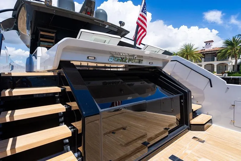 Snack Money Yacht Photos Pics 2023 Bluegame BG 72 yacht with sleek design, wooden steps, and American flag.