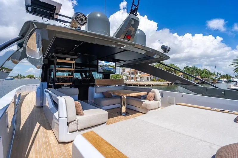Snack Money Yacht Photos Pics Luxurious 2023 Bluegame BG 72 yacht with spacious deck and modern seating area.