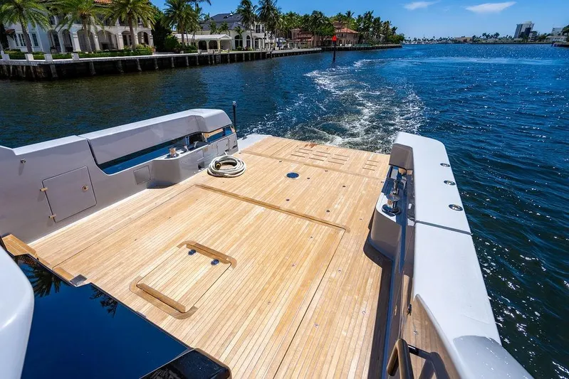 Snack Money Yacht Photos Pics 2023 Bluegame BG 72 yacht deck cruising on a sunny waterfront.
