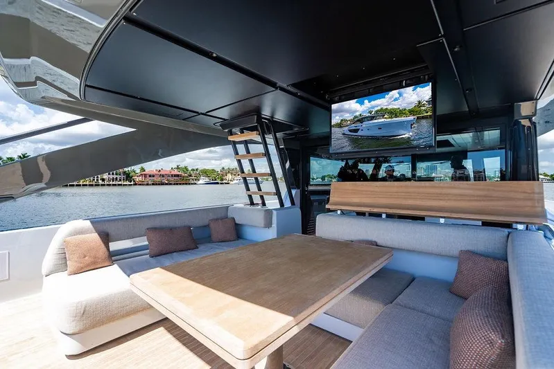 Snack Money Yacht Photos Pics Luxurious interior of 2023 Bluegame BG 72 yacht with comfortable seating and waterfront view.