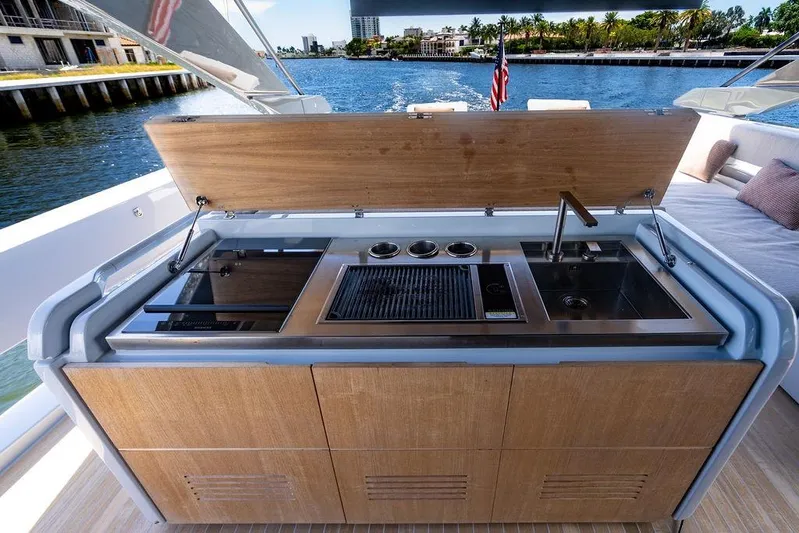 Snack Money Yacht Photos Pics Outdoor kitchen on 2023 Bluegame BG 72 yacht with grill and sink, overlooking water.